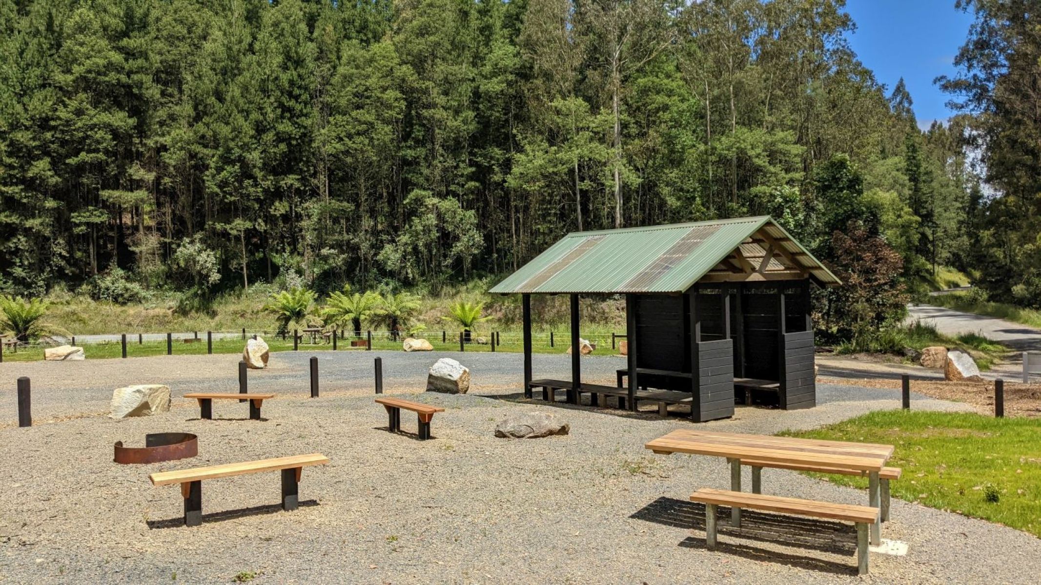 Picnic shelter at Checking Station. Also a fire pit with 3 wooden benches and a wooden picnic table. 