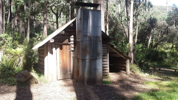 A historic timber hut with tin chimney