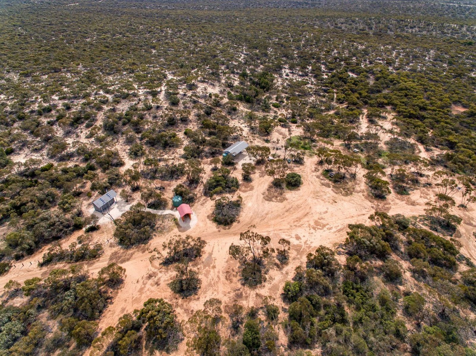 This image shows the Big Billy Bore Camping and Picnic area in the Big Desert State Forest. It is surrounded by desert with remote vegetation. 