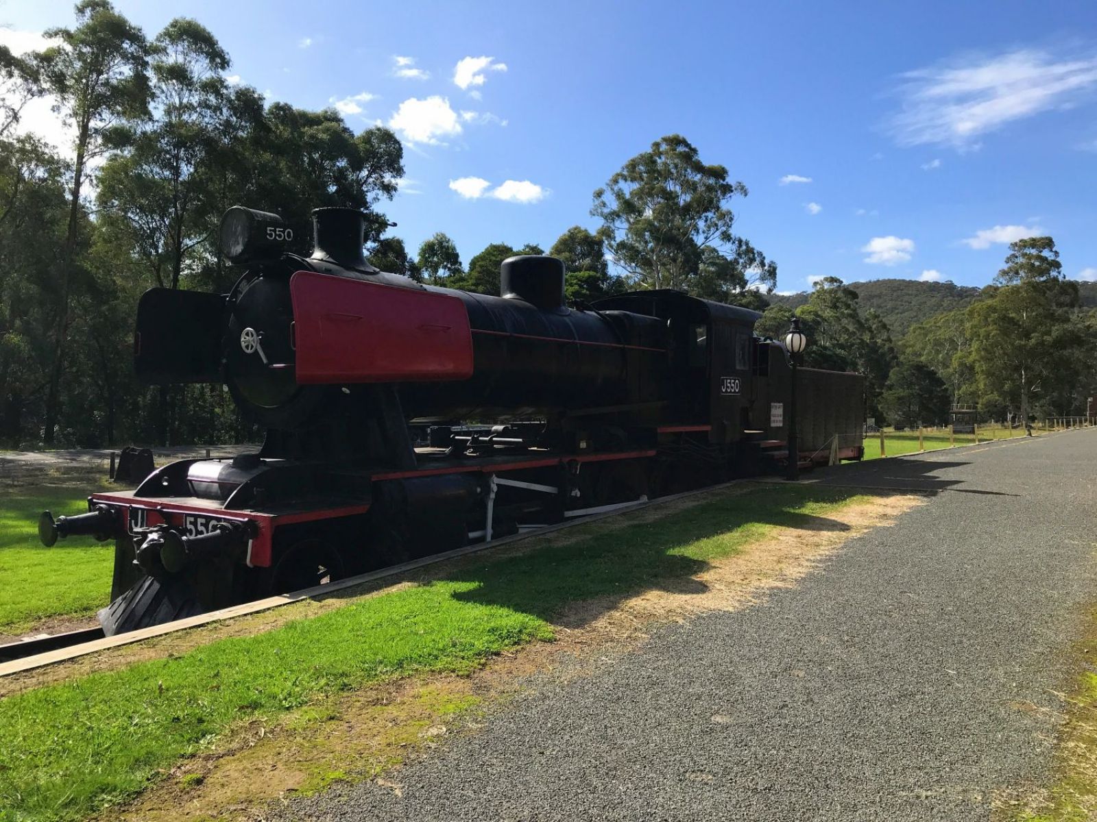 Old black stream train with red accents at the start of walk