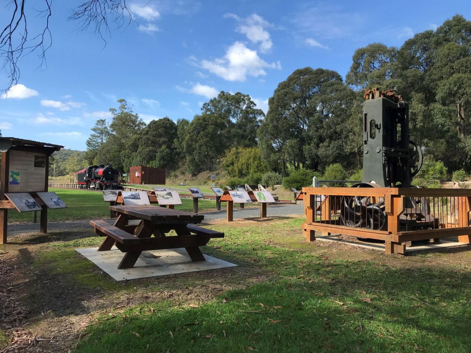 Interpretive material at the trailhead including a wooden picnic table