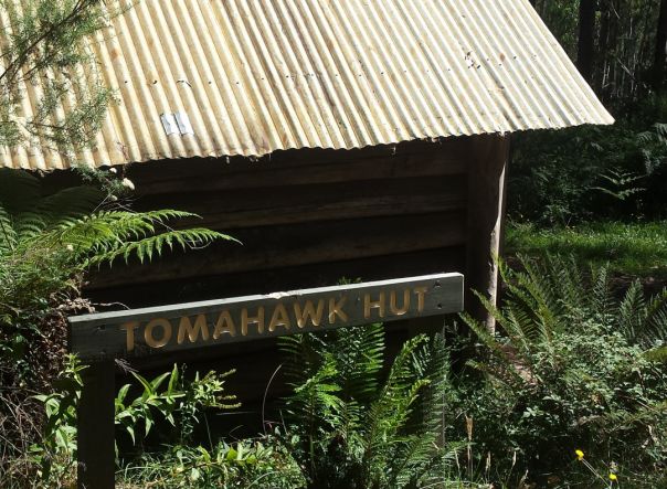 A sign outside a historic shelter reads Tomahawk Hut